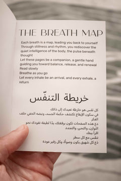Open Nafas Breath Map booklet showing English and Arabic introduction about mindful breathing, held in hand.